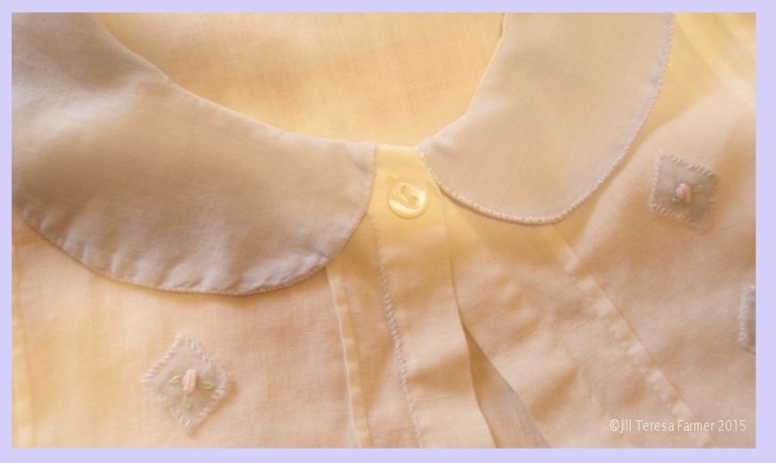 One of grandmother's tiny pearl buttons on a baby dress she made in the 1920s. ©Jill Teresa Farmer